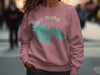 Rose pink sweatshirt with turquoise Marco Island map and compass graphic.