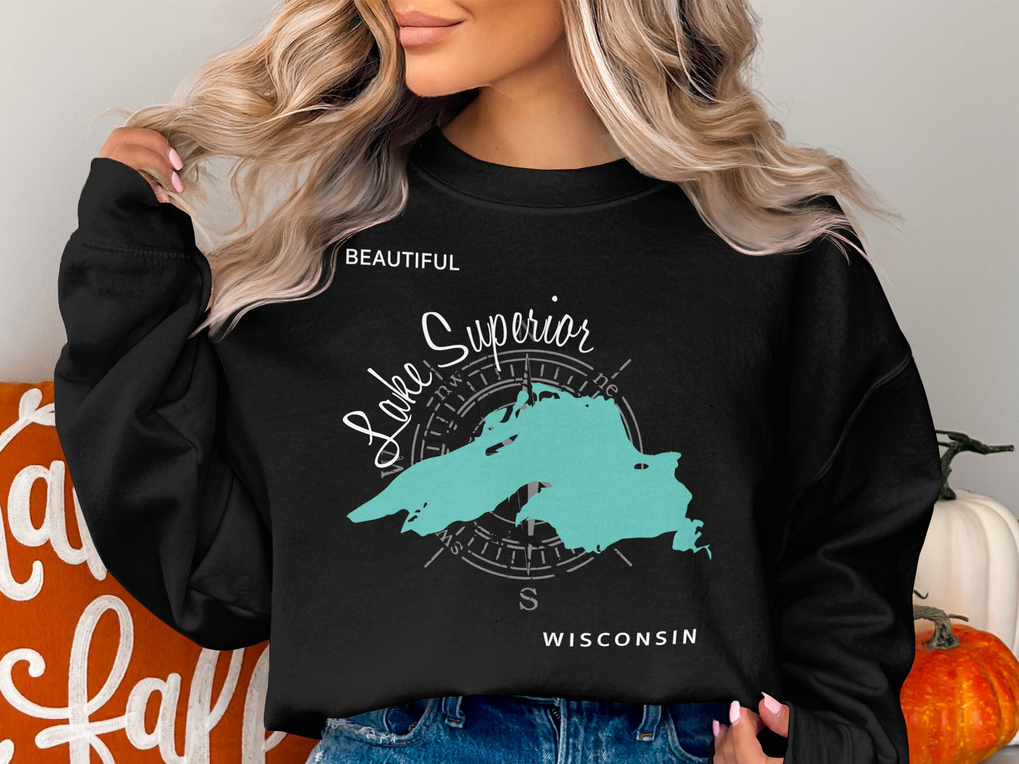 Black sweatshirt with teal outline of Lake Superior and compass rose.