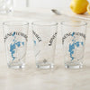 Three clear pint glasses featuring a blue map of Minong Flowage, Wisconsin, and a compass rose.