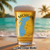 Beer glass with Michigan outline and "Lake Michigan" text on a beach.