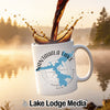 White mug with Nantahala Lake map and compass design, coffee pouring in.
