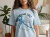 Light blue t-shirt with Pokegama Lake Minnesota map graphic and compass.