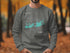 Gray sweatshirt with a teal map of Key West and compass rose design.