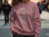 Pink sweatshirt featuring a compass graphic and "Lake Oahe North Dakota" text.