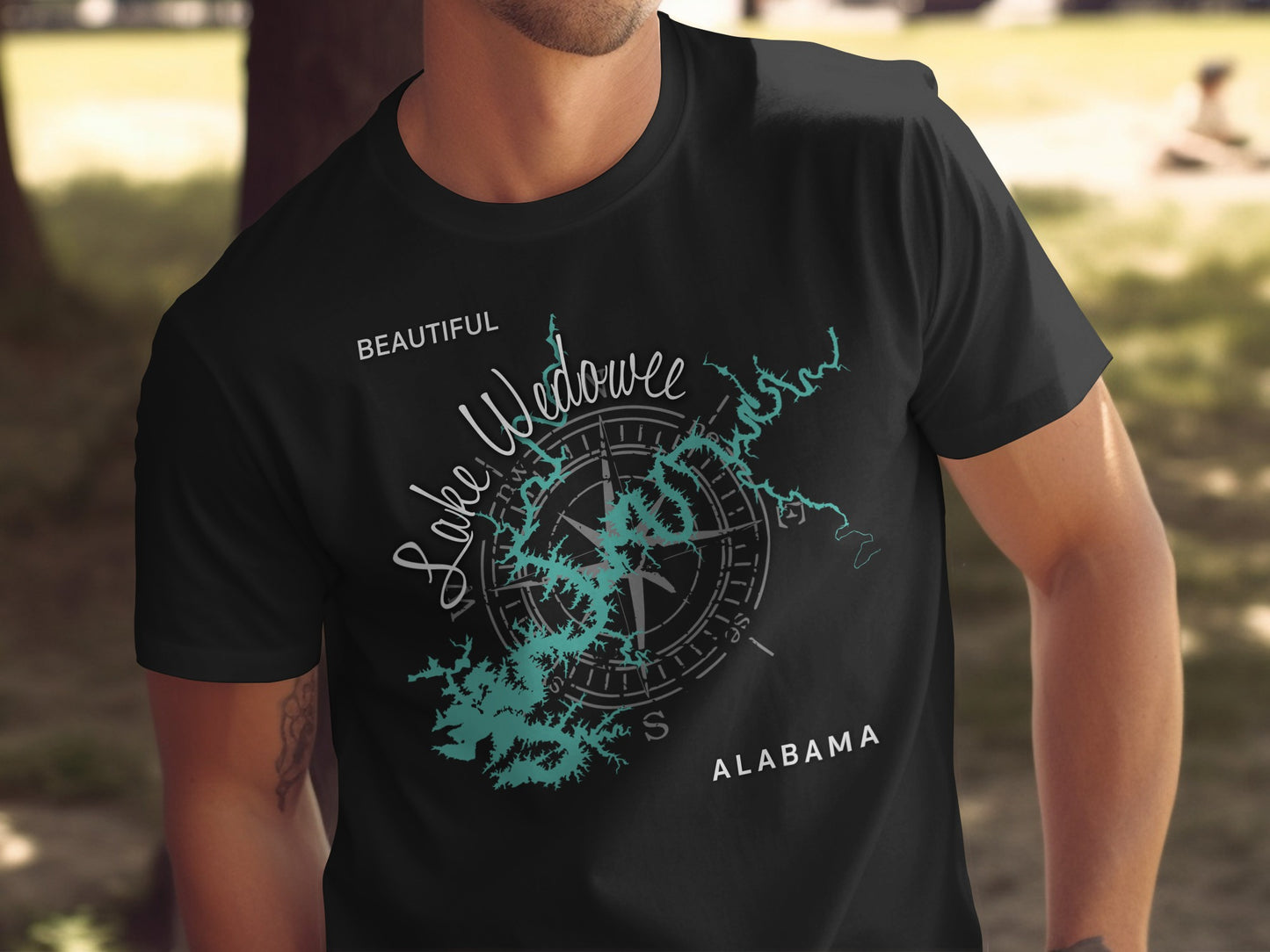 Black t-shirt featuring a teal compass rose overlaying a map of Lake Wedowee, Alabama.