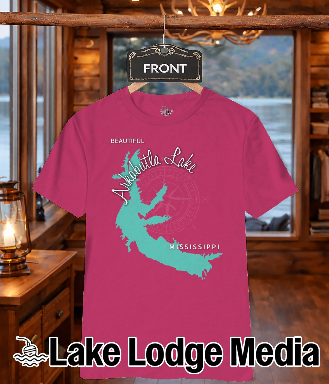 Pink t-shirt with a turquoise outline of Mississippi and "Lake Lodge Media" text.