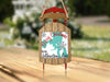 Sled ornament with "Merry Christmas from Yellowstone Lake" text and snowflakes.