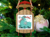 Sled ornament with "Merry Christmas FROM Lake St. Clair" text on a Christmas tree.