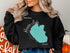 Black sweatshirt with "Beautiful Hauser Lake Idaho" text and lake outline.