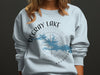 Light blue sweatshirt featuring De Gray Lake Arkansas design with compass rose.