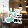 Turquoise lake outline sticker with text "Your Custom Life" and copyright.