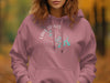 Pink hoodie with "Lake Travis Texas" text and compass design.