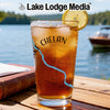 Glass with iced tea, lemon slice, and Chelan Washington map design on Lake Lodge Media logo.