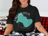 Black t-shirt with turquoise Lake Calhoun map graphic and "Georgia" text.