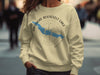Cream sweatshirt with blue Theodore Roosevelt Lake map graphic and compass.