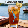 Glass with Lake Winnisquam map and compass design, topped with lemon.