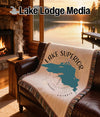 Lake Lodge Media blanket with Lake Superior map and compass design.
