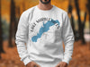 White sweatshirt with blue Lake Marble Falls map over a compass design.