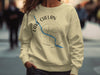 Light yellow sweatshirt with Lake Chelan Washington text and compass rose design.