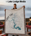 Man holding a Lake LBJ Texas map blanket with a compass rose design.