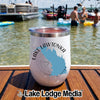 White stainless steel insulated tumbler with a compass and Lake Lawtonka, Oklahoma graphic sitting on a wooden boat deck.