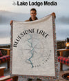 Man holding a blanket with "Bluestone Lake West Virginia" and compass design.