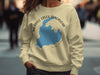 Light yellow sweater with Merrill Creek Reservoir map and compass graphic.