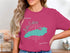 Pink t-shirt with turquoise Lake Ontario map and compass rose design.