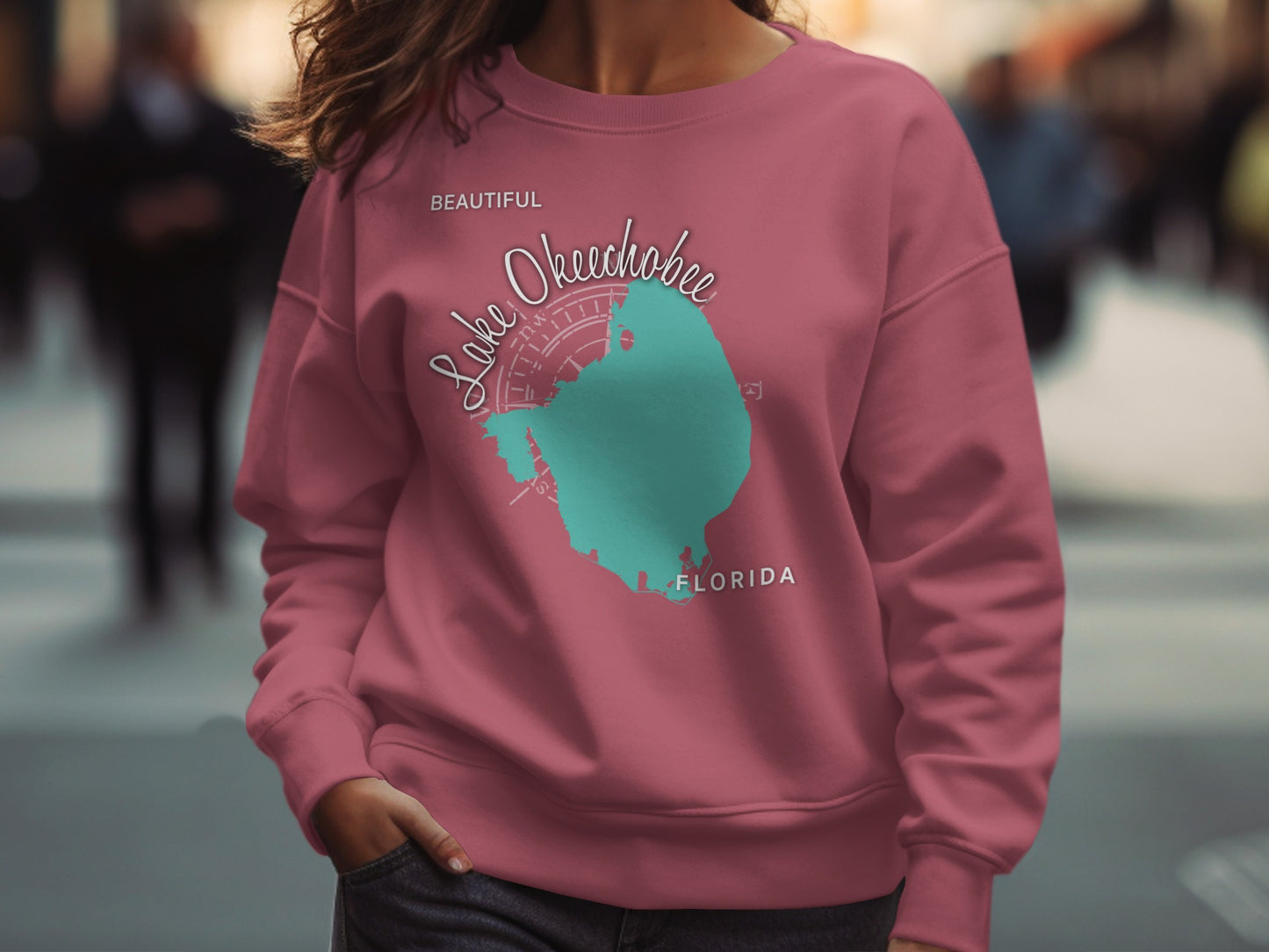 Pink sweatshirt with teal Lake Okeechobee Florida map graphic.
