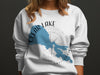 White sweatshirt with Clear Lake California map and compass design.