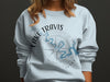 Light blue crewneck sweatshirt with a compass rose map of Lake Travis, Texas graphic.