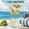 Glass of sparkling beverage with lime, mint, and ice; beach background.