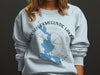 Light blue sweatshirt with a map of Mooselookmeguntic Lake and compass design.