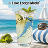 Glass with "Lake Las Vegas Nevada" text, limes, mint, and ice on a beach background.