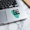 Teal sticker with "Black Lake Life" text on a laptop.