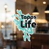 Turquoise abstract sticker with black text reading "Tapps Life" on glass.