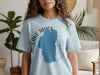 Light blue t-shirt with Lake Tahoe silhouette and compass graphic.