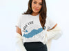 White t-shirt with Lake Erie map and compass graphic, "Lake Erie New York" text.