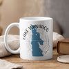 White mug with blue Lake Wahoo map and compass design, "NEBRASKA" text.