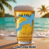 Beer glass with "Acadia Lake" text and blue lake outline on a beach.