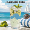 Glass with Lake Superior map, lime, mint, and ice on a beach background.