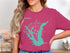 Teal map of Lake Calaveras, Texas with compass rose graphic on pink t-shirt.