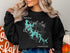 Black sweatshirt with Priest Lake map and compass graphic.