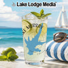 Glass with Lake Murray design, limes, mint, and iced drink on beach background.