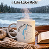 White mug with Abraham Lake Alberta design, steaming hot drink.