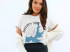 White t-shirt with Hayden Lake Idaho map and compass graphic.