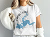 White t-shirt with blue Caddo Lake map and Texas graphic.