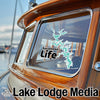 Bumper sticker of Tuscaloosa Life and lake outline on boat window next to "Lake Lodge Media."