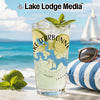 Glass with "Lake D'Arbonne" map design and lime, on a beach with sailboat.