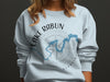 Light blue sweatshirt with Lake Rabun, Georgia map and compass design.